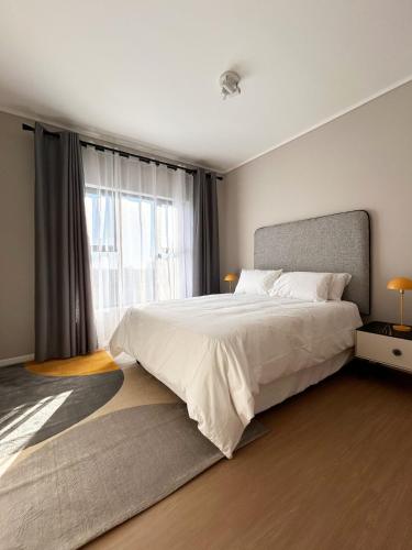 a bedroom with a large bed and a large window at 95 Yang Suite A in Johannesburg