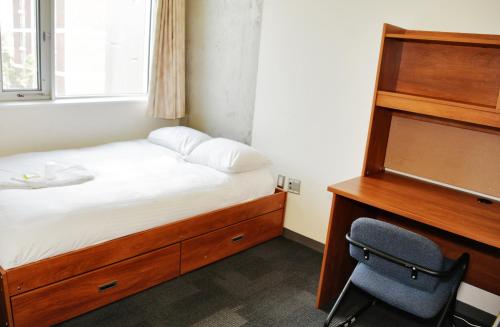 a bedroom with a bed and a desk and a chair at Carleton University – Ottawa in Ottawa