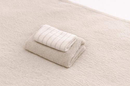 a white towel sitting on top of a bed at 6 minutes walk from Ichikawa Station Single-family house with 3 bedrooms and 1 living room Rich living facilities around in Ichikawa
