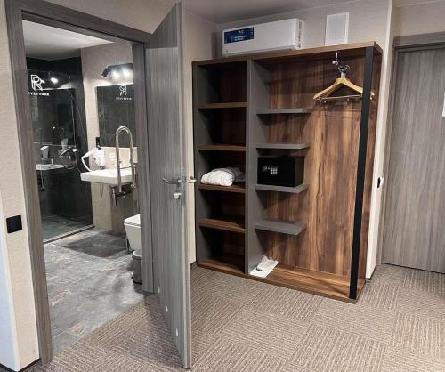 a bathroom with a sink and a toilet in a room at Optima Collection River Park in Lutsk