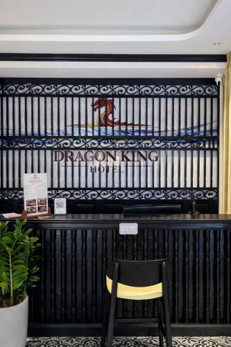 a yellow chair sits in front of a black wall at Dragon King Hotel Nghệ An in Cửa Lô
