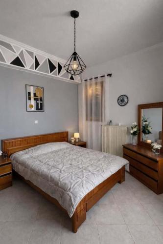 a bedroom with a large bed and a mirror at Christina's house in Kipséli