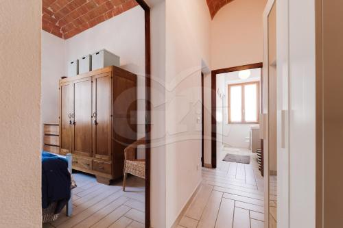 a hallway with a door leading to a bathroom with white walls at Appartamento Zoe - Goelba in Marina di Campo