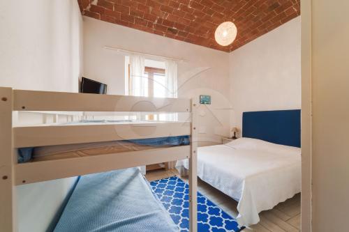 a room with two bunk beds and a bed at Appartamento Zoe - Goelba in Marina di Campo