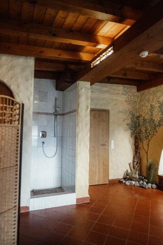 a large bathroom with a shower in a building at Pension Singer in Innsbruck