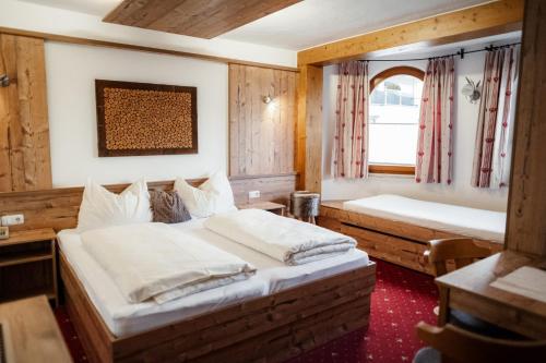 a bedroom with two beds and a window at Pension Singer in Innsbruck