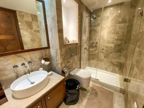 a bathroom with a sink and a toilet and a shower at The Amathountas Residence in Pyrgos