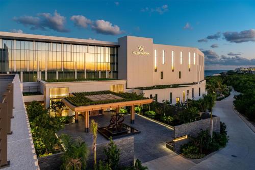 an external view of a building with a garden at Waldorf Astoria Riviera Maya in Cancún