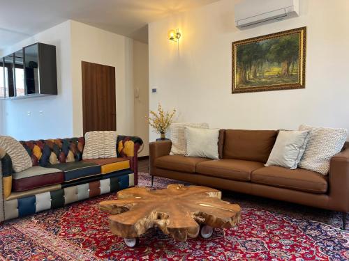 a living room with two couches and a wooden coffee table at Menaggio Lake Como Elegance in Menaggio