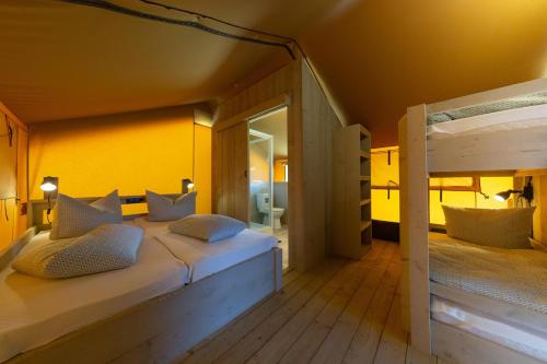 a bedroom with two bunk beds and a mirror at Sonnenkap Camping in Prenzlau