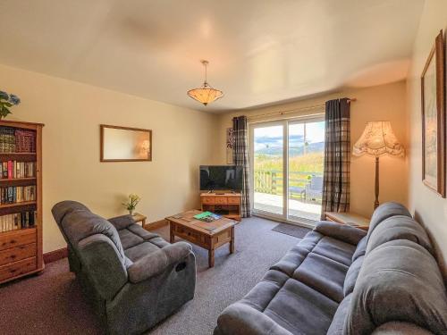 a living room with a couch and a tv at Uk47551 - Cree View Cottage in Newton Stewart