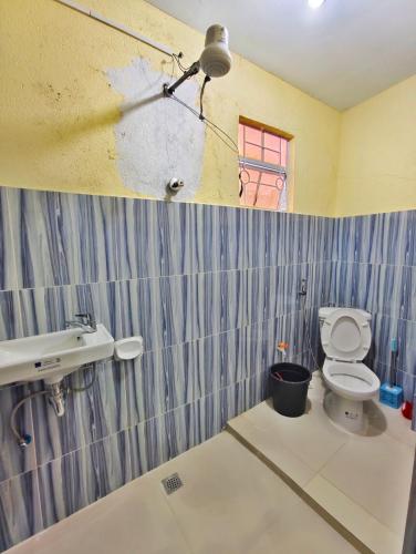 a bathroom with a toilet and a sink at Best Sagada Lodge within City Proper! in Sagada