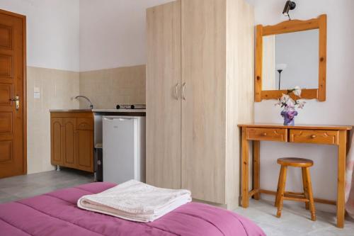 a kitchen with a purple bed in a room at Ionian Breeze Apartments in Kavos