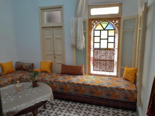 a living room with a couch and a window at dar rachid in Fez