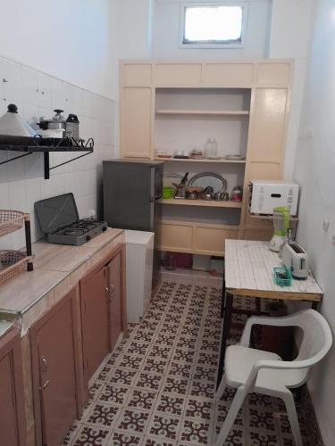 a small kitchen with a table and a sink at dar rachid in Fez