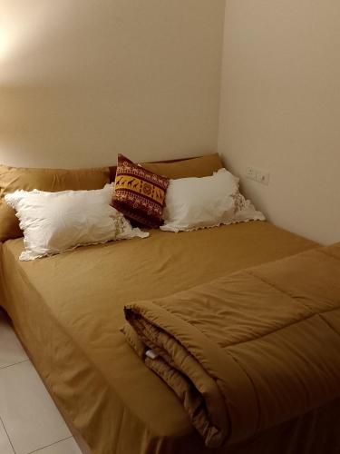 a bed with two pillows on it in a room at MaEra's Den in Hinjewadi