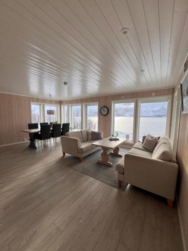 a living room with two couches and a table at Ocean View Cottage in Alta