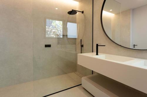 a bathroom with a sink and a mirror at Villa Anjos - Luxury Villa with Infinity Pool & Ocean View in Canhas