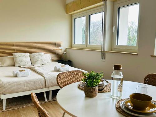 a living room with a bed and a table with a tableablish at Il Colle in Buia
