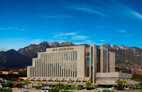 a mgm metropolitan building with mountains in the background at MS Milenium Monterrey Curio Collection by Hilton in Monterrey