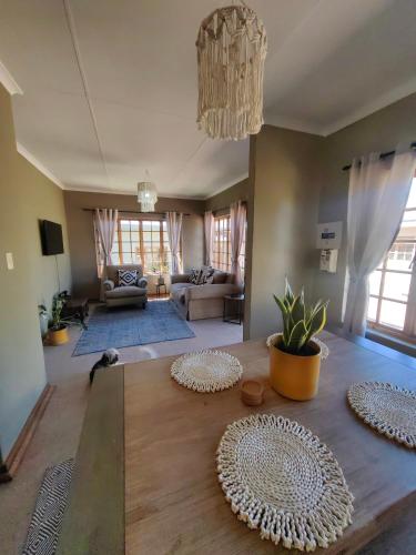 a living room with a table and a couch at Meya B in Harrismith