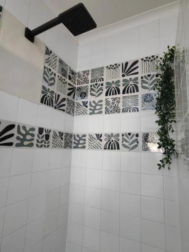 a bathroom with black and white tiles on the wall at Meya B in Harrismith