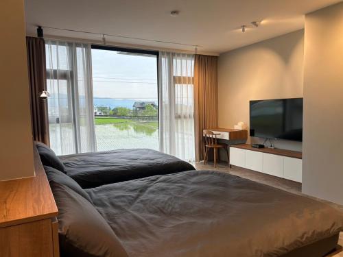 a bedroom with a large bed and a large window at Find 777 B&B in Guilin