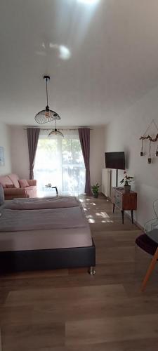 a bedroom with a bed and a desk and a television at Juliusruh Strandparadies 2 in Juliusruh