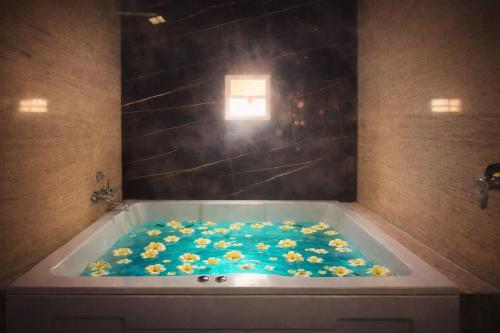 a bath tub filled with flowers in a bathroom at Elegant Residency in Coimbatore