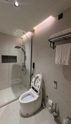a bathroom with a toilet with a robot on it at فندق جولدن نيو سمارت لاكجري - Golden New Smart Hoteluxury in Abha