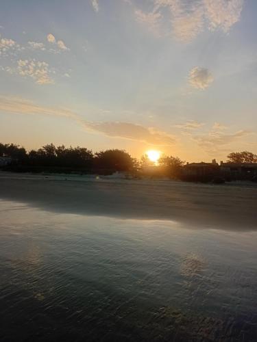 a sunset over a large body of water at Cabanas Sol e Lua in Imbé