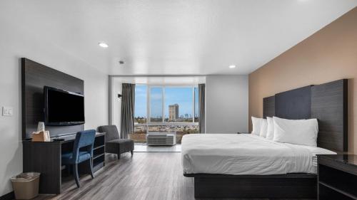 a hotel room with a bed and a desk and a television at Oceanside, CA – Marina / Camp Pendleton in Oceanside