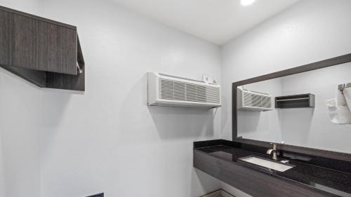 a bathroom with a sink and a mirror at Oceanside, CA – Marina / Camp Pendleton in Oceanside