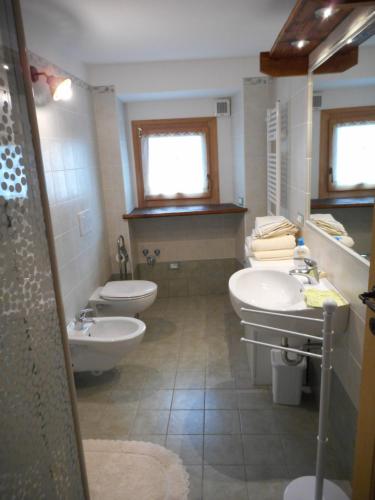 a bathroom with two sinks and two toilets at Le Petit Soleil in Saint-Christophe