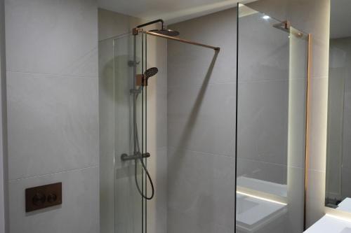 a shower with a glass door in a bathroom at 1st Floor Luxury 2-Bed Apt Sleeps 6 in St. Andrews
