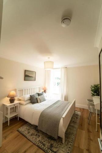 a bedroom with a large bed and a window at Foundry Farm House - 4 bedrooms in Hexham