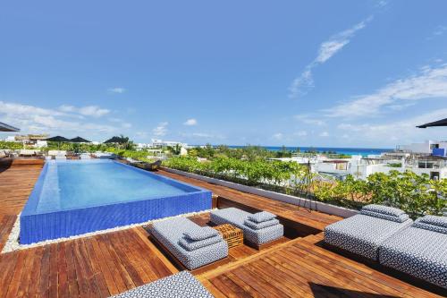 an outdoor swimming pool on the roof of a house at The Yucatan Playa Del Carmen, Tapestry Collection By Hilton in Playa del Carmen