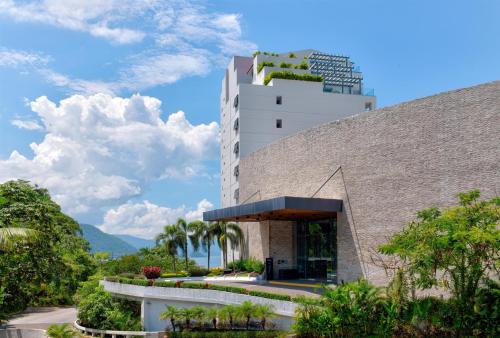 a building with a plant on the top of it at Hilton Vallarta Riviera All-Inclusive Resort,Puerto Vallarta in Puerto Vallarta