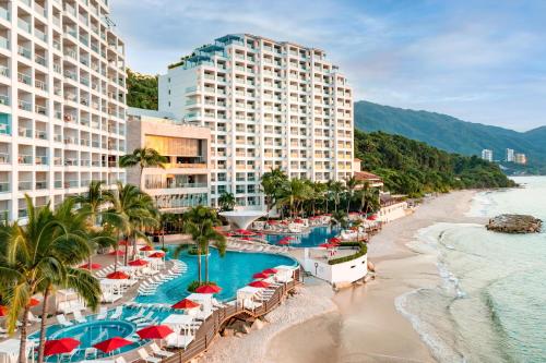 an aerial view of a resort with a beach and buildings at Hilton Vallarta Riviera All-Inclusive Resort,Puerto Vallarta in Puerto Vallarta