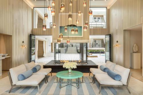 a living room with two couches and a table at Oceana Santa Monica, LXR Hotels & Resorts in Los Angeles