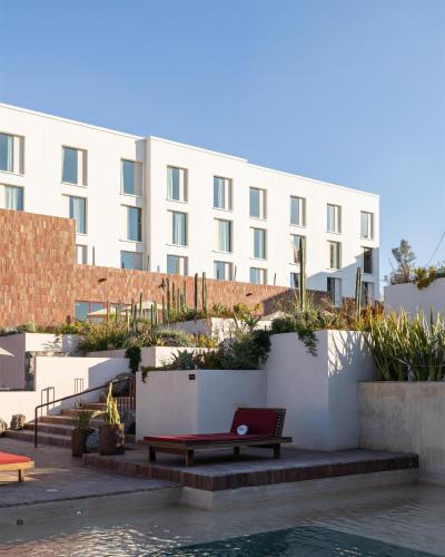 a building with a bench next to a pool at Albor San Miguel de Allende, Tapestry Collection by Hilton in San Miguel de Allende