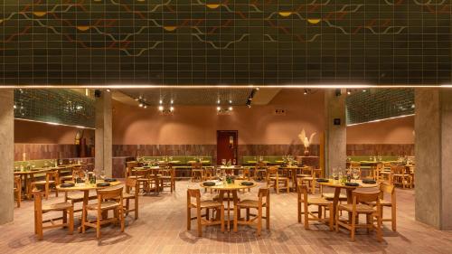 a restaurant with tables and chairs in a room at Albor San Miguel de Allende, Tapestry Collection by Hilton in San Miguel de Allende