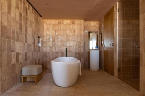 a bathroom with a large tub and a shower at Albor San Miguel de Allende, Tapestry Collection by Hilton in San Miguel de Allende