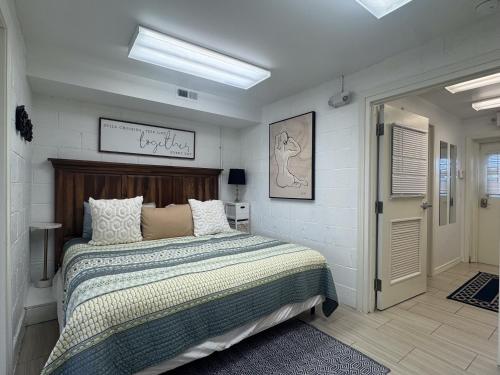 a bedroom with a large bed with a wooden headboard at Contemporary Dual-Unit 2BR Downtown Branson - Free Tickets Included - LOFT in Branson