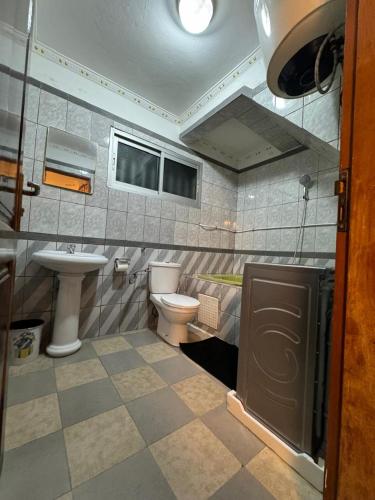 a bathroom with a sink and a toilet at Afraah guest house in Yaoundé