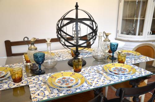 a table with plates and a lamp on it at La piccola corte in Ravenna