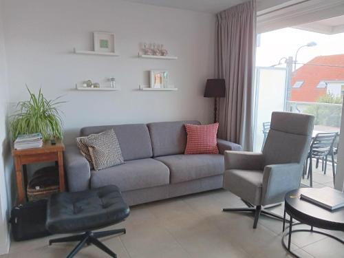 a living room with a couch and two chairs at Zilt 0202 in Westende