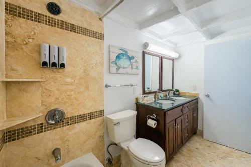 a bathroom with a toilet and a sink at Palms Resort and Beach in La Grande Princesse
