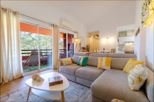 a living room with a couch and a table at Oasis of Aroeira Golf & Beach House in Aroeira
