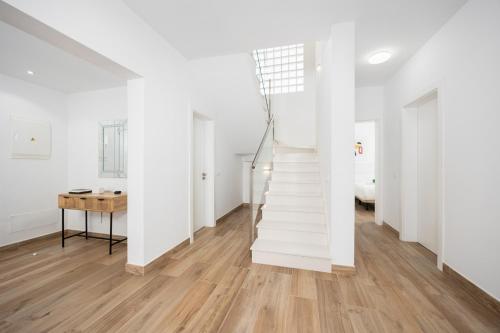 a white staircase in a white room with a table at Villa Yaiza Secret 2 in Yaiza